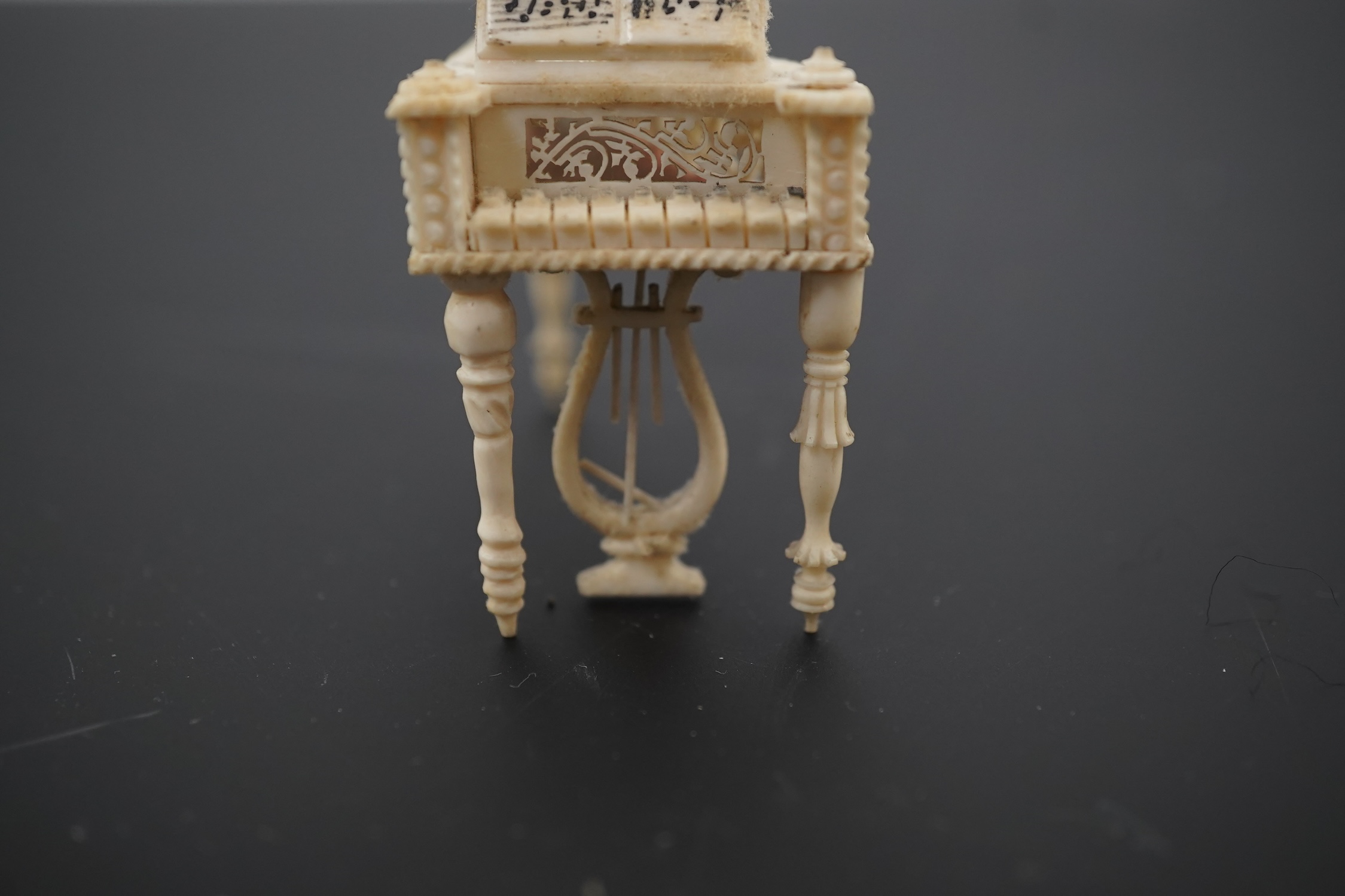 A Napoleonic Prisoner of War bone miniature model of a harpsichord, 6.5cm long. Condition - good